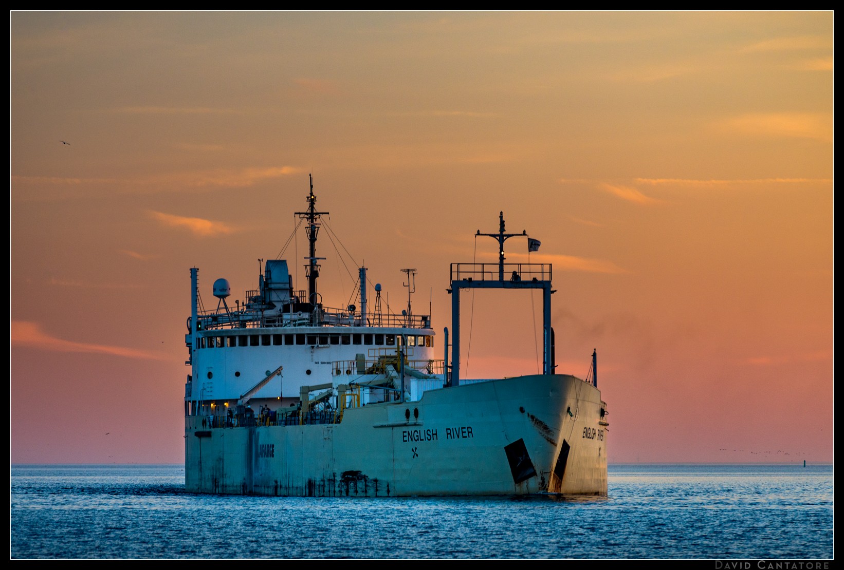 Freighter entering the Toronto harbour at sunset.